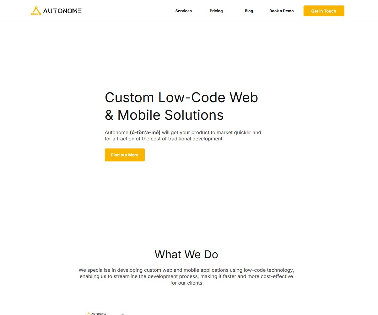 The 2023 Autonome homepage: the new yellow triangle logo and the headline Custom Low-Code Web & Mobile Solutions, with the pronunciation ô-tŏn′ə-mē.